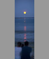 The Full Moon atop a boat mast