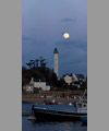 The Full Moon is emerging from behind the clouds