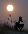 Sabine is reading, lighting by the Moon
